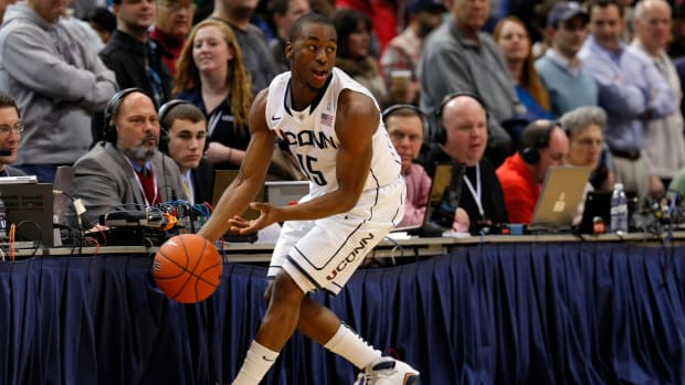 Connecticut Huskies guard Kemba Walker grabs the ball.
